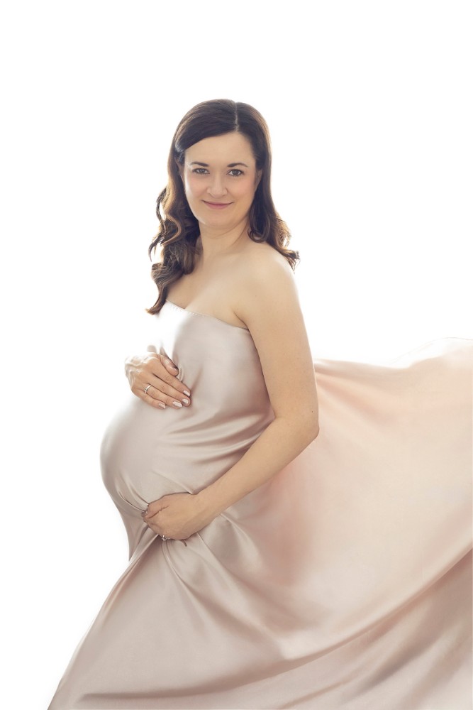 Artistic maternity session in Billericay with flowing blush silk, perfect for capturing precious pregnancy moments in Essex