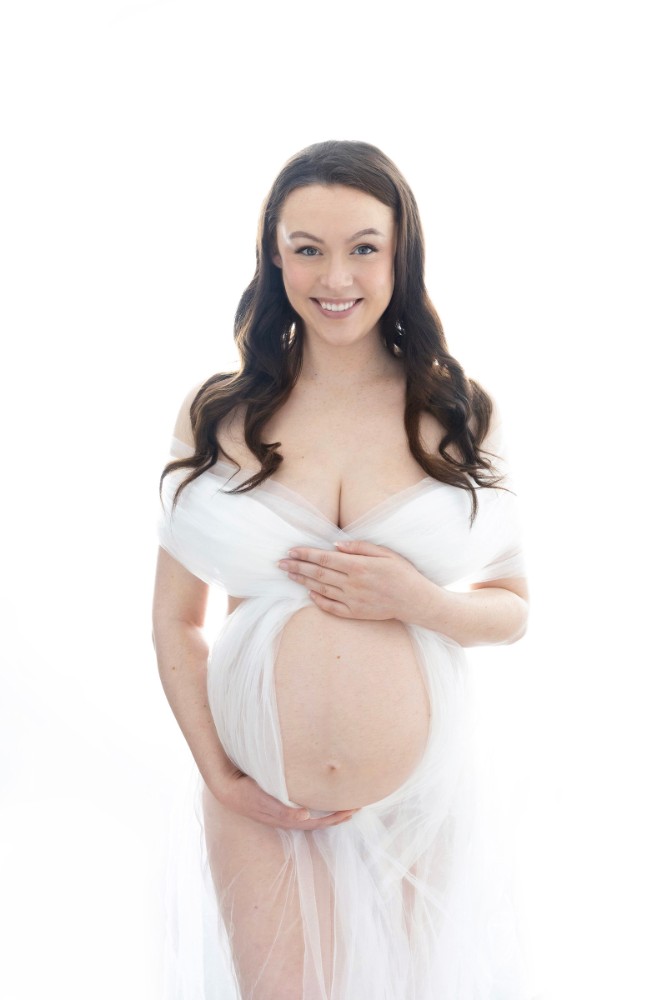 Elegant Essex pregnancy portrait session with creative lighting and outfit details