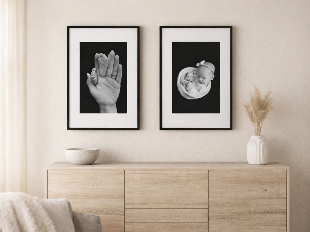 Black and white newborn fine art prints featuring baby feet in parent hands and sleeping newborn portrait displayed in a Colchester Essex home