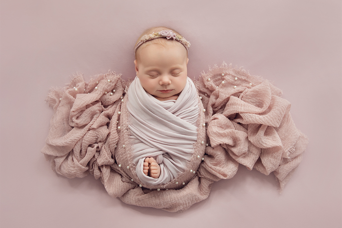 In-home newborn photography session in Essex with a sleeping baby photographed in a calm home environment