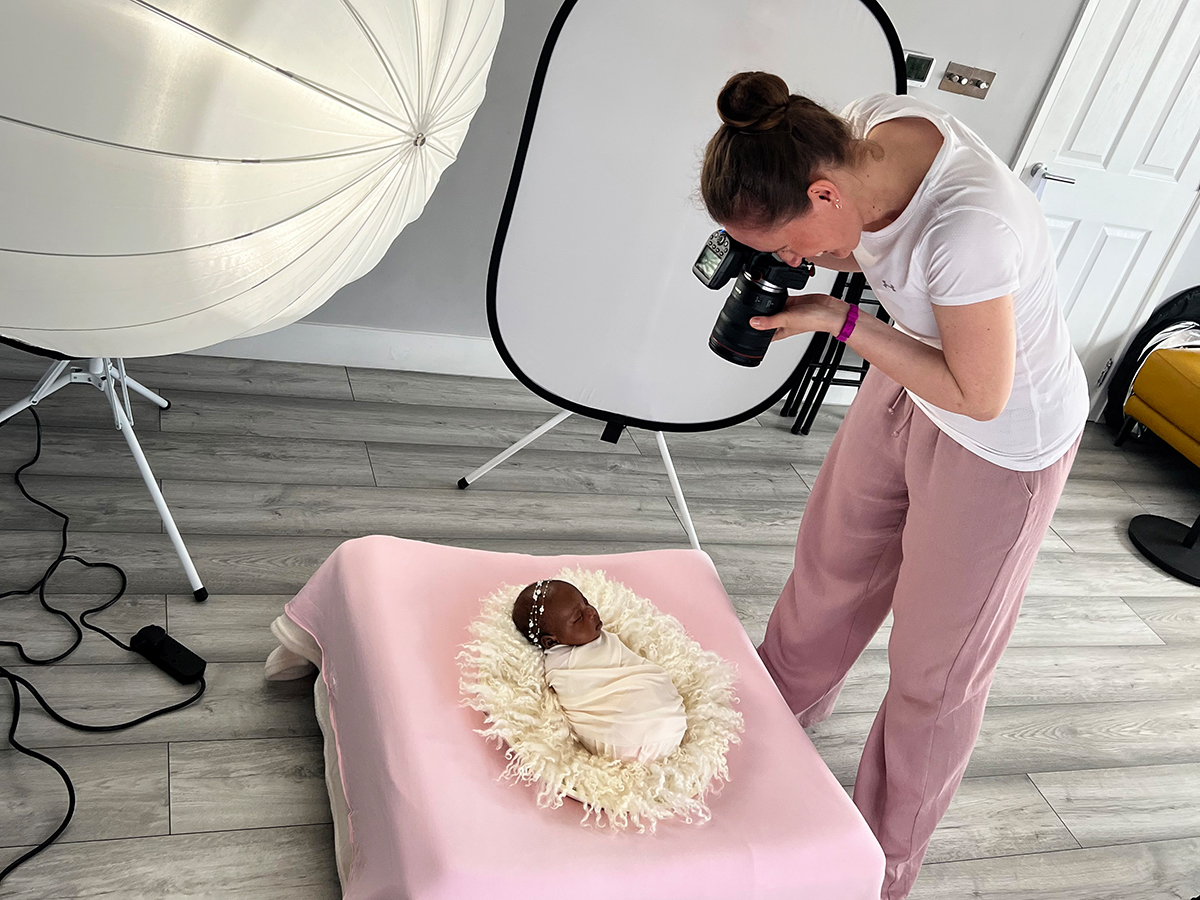 Professional mobile newborn photographer creating a luxury fine art newborn portrait during an in-home photography session in Essex.
